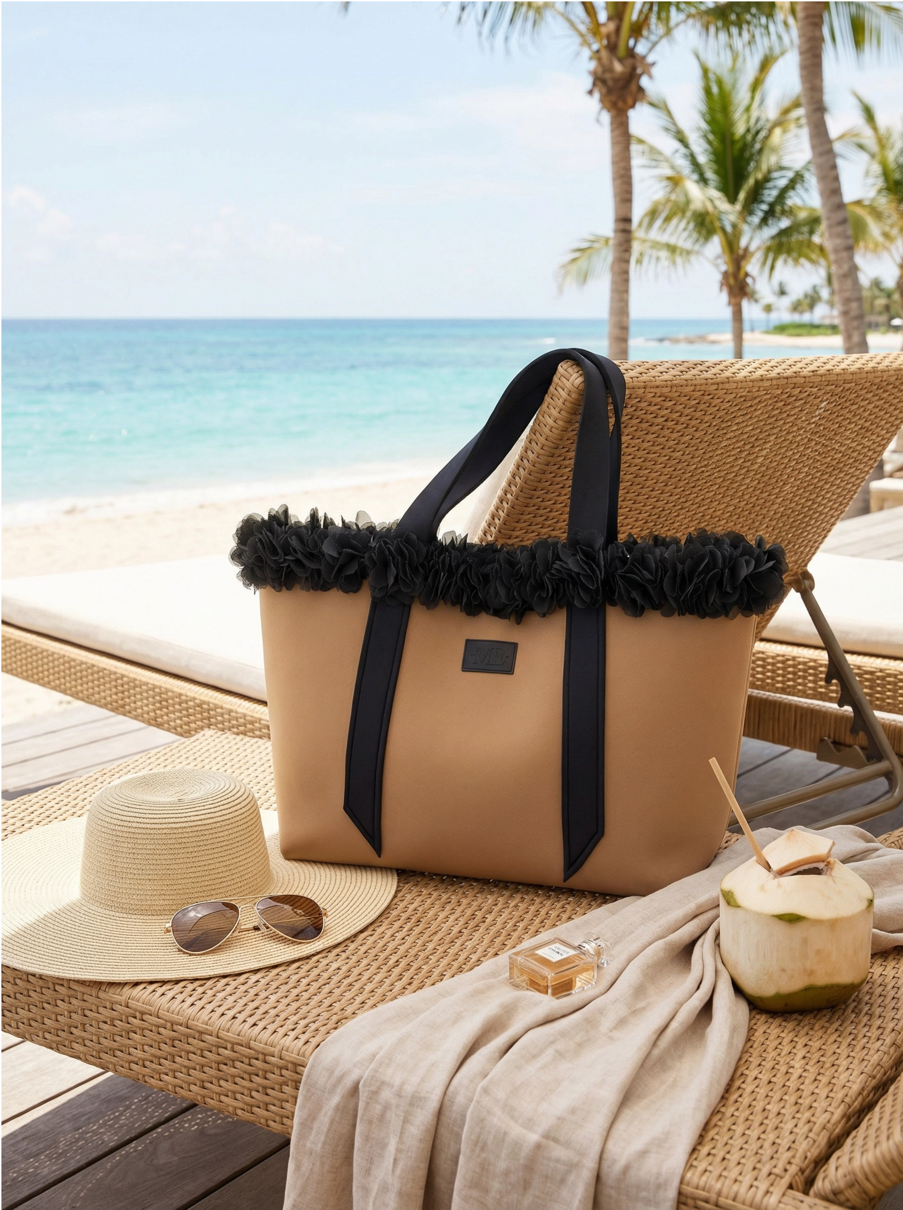 Beige tote bag with black trim on a beach chair by the ocean