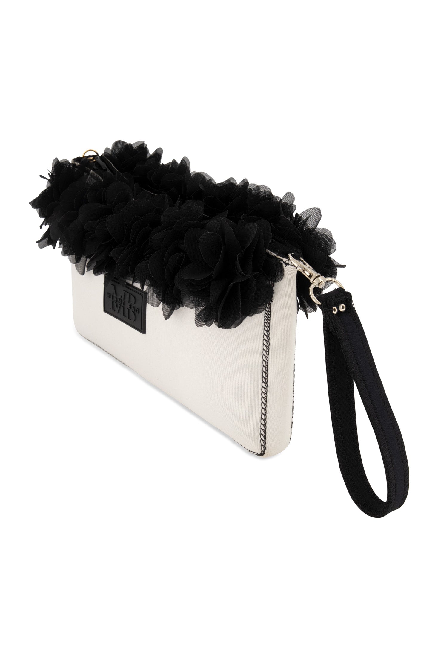 White clutch with black floral decorations on a white background